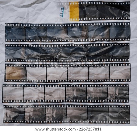  set of retro long 35mm positive strips printed on white crumpled paper, contact sheet with empty frames or film cells. cool cover or poster idea.