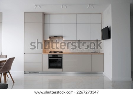 Modern Contemporary kitchen room interior .white and wood material. real new interior design Royalty-Free Stock Photo #2267273347