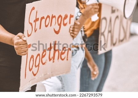 Protest, sign and equality with a group of people holding cardboard during a rally or march for freedom. Street, community and justice with a crowd fighting for human rights or a politics campaign