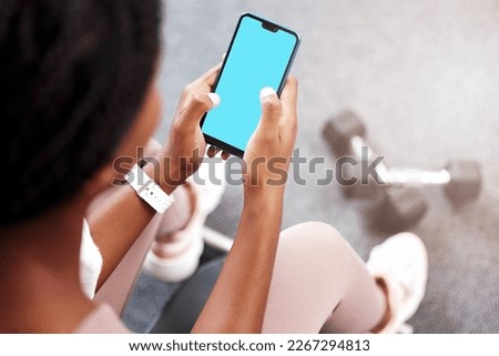 Fitness, smartphone in hands and mockup with green screen, black woman and app for exercise and weightlifting with dumbbell in gym. Sports marketing, wellness and phone with virtual workout class.
