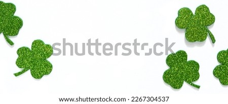 Happy St. Patrick's Day banner.Holiday background.St Patricks Day frame against a white background. Flat lay shamrocks.Copy space.Patrik's day banner Royalty-Free Stock Photo #2267304537