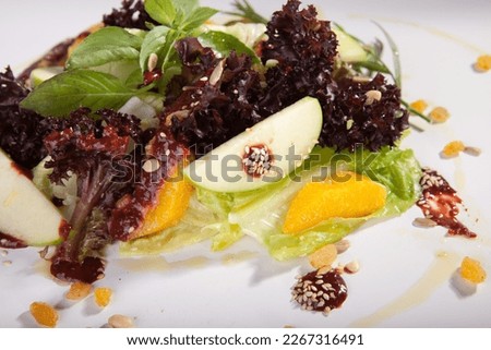 green salad with orange in white back