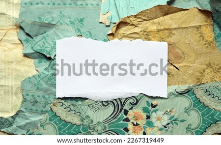 White sheet of paper on old torn wallpaper on the wall.Old wallpaper for texture or background.