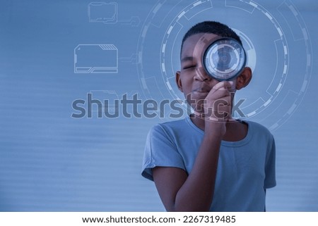 Boy holding the magnifying glass, Little kid boy holding and looking through magnifying glass showing a big eye