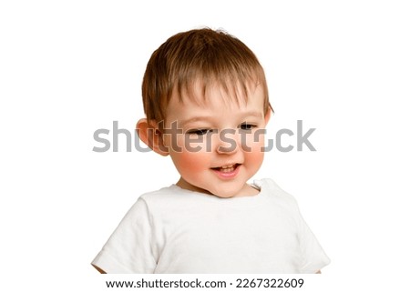 Portrait of a happy toddler baby on a studio isolated on a white background. Smiling child in a white t-shirt, copy space. Kid aged one year and four months