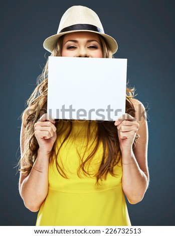 young woman holding white blank card . isolated studio portrait .