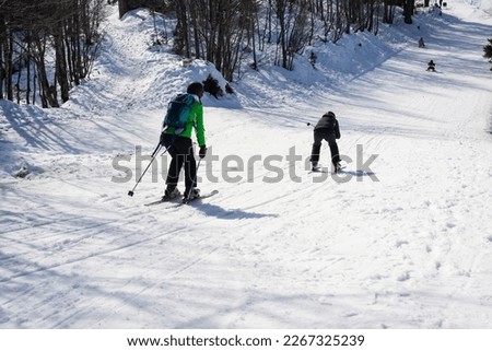 Group of unrecognizable skiers on the slope at mountain ski resort