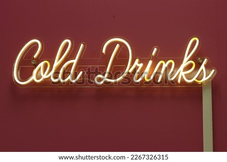 neon cold drinks sign on wall