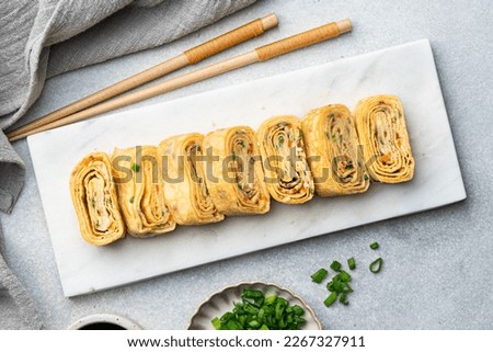 Tamagoyaki, Japanese rolled omelette, top view Royalty-Free Stock Photo #2267327911