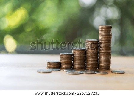 Stacks of coins placed on the table over nature green background, concept finance business investment with copy space, Investment concept future financial planning after retirement