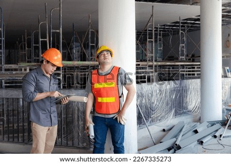 Engineer or Architect discussing with contractor about project in building construction site.g construction site. Royalty-Free Stock Photo #2267335273
