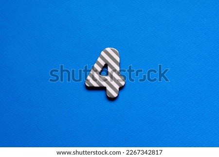 number four on blue paper background