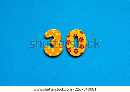 numeric thirty on blue paper background