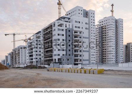 Finishing work on construction site in the north district of Israel, new apartment buildings are growing. Completed new houses with ground in front. Royalty-Free Stock Photo #2267349237