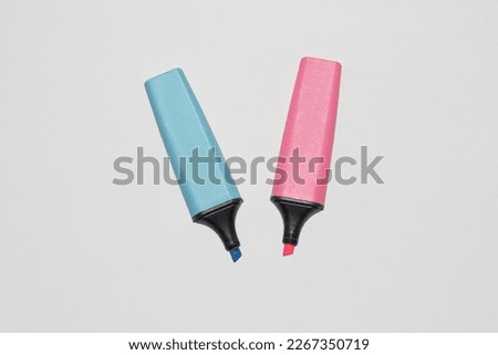 Blue and pink marker pens to highlight text on the book, white background isolated Royalty-Free Stock Photo #2267350719