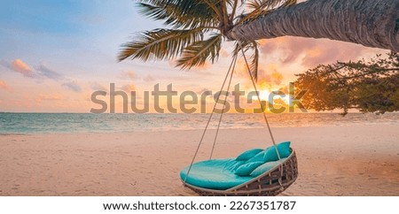 Romantic beach sunset. Palm tree with swing hanging before majestic clouds sky. Dream nature landscape, tropical island paradise, couple destination. Love coast, closeup sea sand. Relax pristine beach Royalty-Free Stock Photo #2267351787