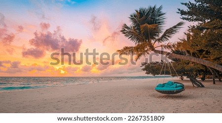 Romantic beach sunset. Palm tree with swing hanging before majestic clouds sky. Dream nature landscape, tropical island paradise, couple destination. Love coast, closeup sea sand. Relax pristine beach Royalty-Free Stock Photo #2267351809