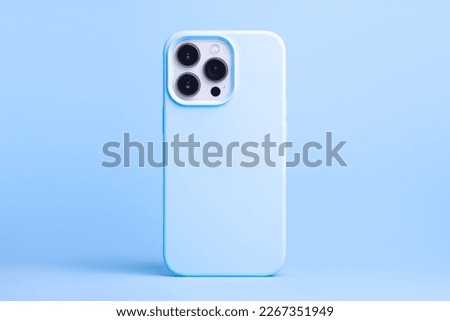 iPhone 13 and 14 Pro Max in blue case back view isolated on blue background, phone cover mock up in monochrome colours Royalty-Free Stock Photo #2267351949