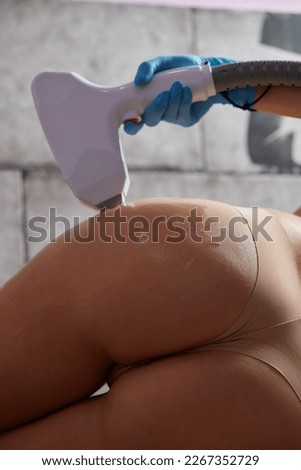 beautician removes hair on beautiful female legs using a laser. hair removal on the legs, laser procedure at clinic