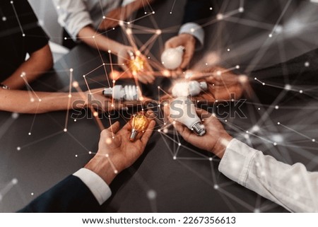 Teamwork and brainstorming concept with businessmen that share an idea with a lamp Royalty-Free Stock Photo #2267356613