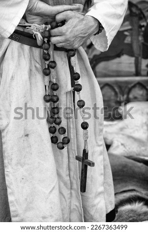 hands priest holds on the cross