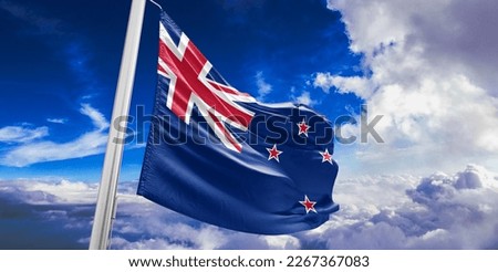 New Zealand national flag cloth fabric waving on beautiful blue sky.