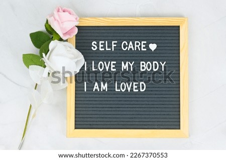 Grey letter board with phrase Self care I loved my body, I am loved. Self love, Mindfulness lifestyle, mental health. Aspiration, affirmative and supportive sentence. Royalty-Free Stock Photo #2267370553