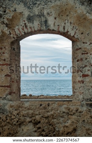 Stunning view of Cartagena's Old City: A window to the sea and horizon, capturing the beauty and history of Colombia.