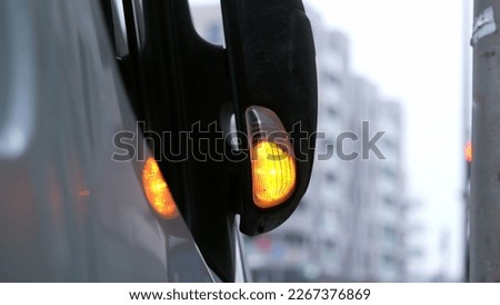 Truck blinking light stop sign in city. Car vehicle light flashing in slow motion