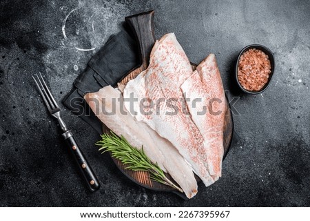 Fresh Raw red perch fillet, Snapper fish on a wooden board. Wooden background. Top view. Royalty-Free Stock Photo #2267395967
