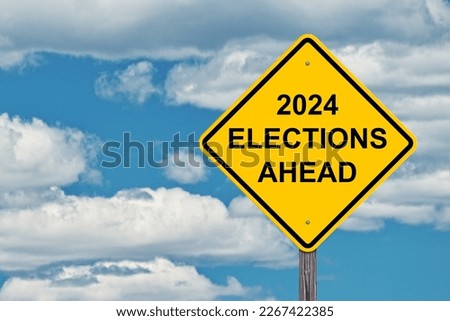 2024 Elections Ahead Caution Sign with Blue Sky Background Royalty-Free Stock Photo #2267422385
