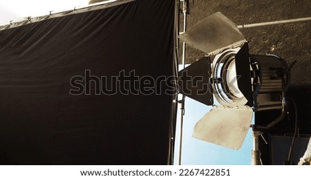 Film light for video production camera in studio set. Use as studio photo shoot lights. Big LED spotlight 5000w and diffuser or black panel create light like sun light can make daytime or golden hour