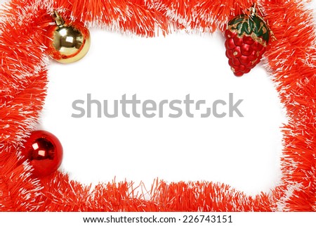 Frame of orange Christmas garland with Christmas toys on a white background