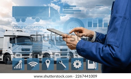 Manager with a digital tablet next to trucks. Fleet management Royalty-Free Stock Photo #2267441009