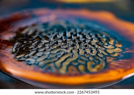Close-up of beautiful abstract patterns created with ferromagnetic liquid and other chemical agents. Royalty-Free Stock Photo #2267453493