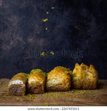 Pistachio baklava. Close-up. Traditional Middle Eastern Flavors. Traditional Turkish baklava. local name fistikli baklava, Pistachio baklava on a dark wooden background. Baklawa on a marble floor. Royalty-Free Stock Photo #2267455611