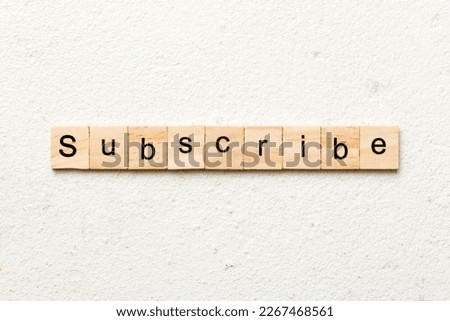 subscribe word written on wood block. subscribe text on table, concept.