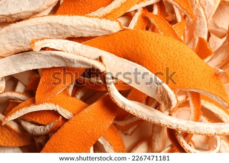 Many dry orange peels on white table, closeup Royalty-Free Stock Photo #2267471181