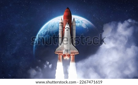 Space shuttle rocket in deep space with clouds and Earth planet. Spaceship on orbit of the planet. Sci-fi space wallpaper. Elements of this image furnished by NASA Royalty-Free Stock Photo #2267471619