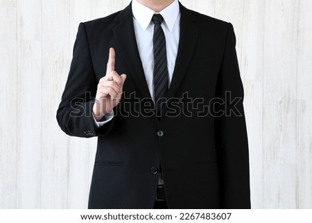 Business man putting up index finger Royalty-Free Stock Photo #2267483607