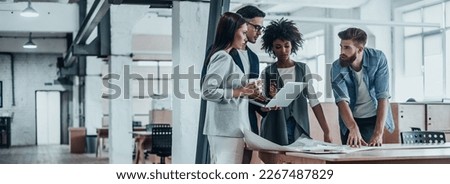 Group of young business people discussing business while working in the office together Royalty-Free Stock Photo #2267487829