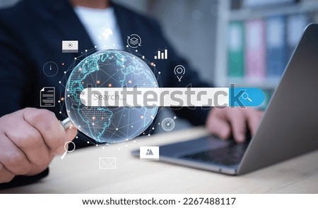 Businessman holding magnifying glasss search for Browsing Internet Data Information Networking Concept, .Internet search page on computer screen.