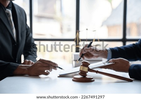 Law concept. Asian young lawyer or legal advisor explaining details Business contract agreement before signing consent to join the business in the real estate project in the office.