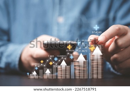 Businessman stacking money coins with up arrow and percentage symbol for financial banking increase interest rate or mortgage investment dividend from business growth concept. Royalty-Free Stock Photo #2267518791