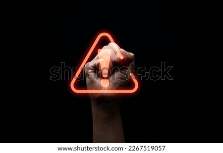 Hand writing red triangle caution exclamation warning sign for notification error and maintenance concept.