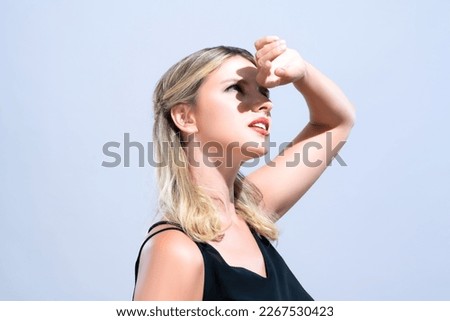 Closeup young blond hair woman with perfect skin and soft alluring facial makeup raise her hand cover her face from bright sunlight in isolated background for skincare sunscreen product. Royalty-Free Stock Photo #2267530423