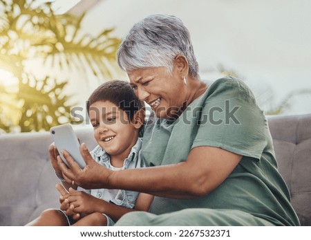 Phone, family or grandmother with child for online games, social media meme and funny video for bonding on sofa. Happy, excited and love of senior woman with kid on smartphone for video call or chat