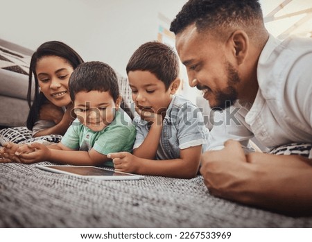 Family, parents and children with tablet, watch video online or streaming with wifi at home and relax, internet and bond. Happy, together and screen time with technology, man and woman with kids Royalty-Free Stock Photo #2267533969