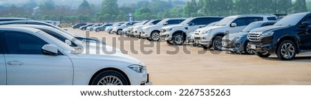 Selective focus white car parked at parking lot. Used car for sale and rental service. Car insurance background. Automobile parking area. Car dealership and dealer agent concept. Automotive industry. Royalty-Free Stock Photo #2267535263