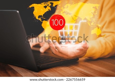 Business online shopping and e-commerce delivery. Hand holding shopping cart icon with internet technology concept. Online web service, provide home delivery service.